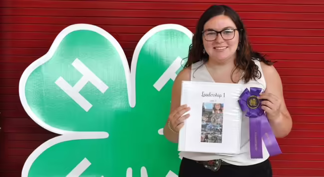 4-H youth shows ribbon with project