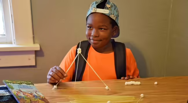 Elementary age child works on STEM project